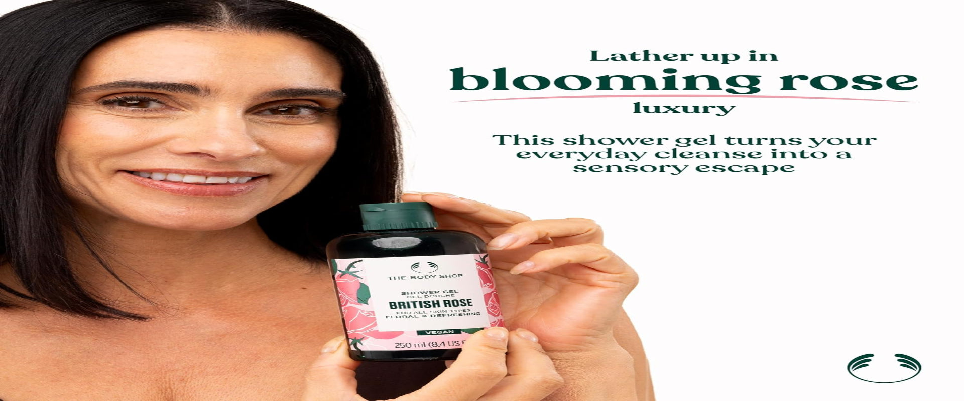 Woman holding a bottle of 'British Rose' shower gel with promotional text on a white background